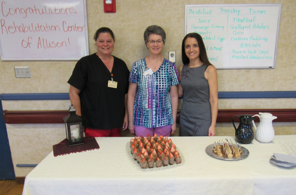 Dorothy McClure at a celebration with a colleague and resident