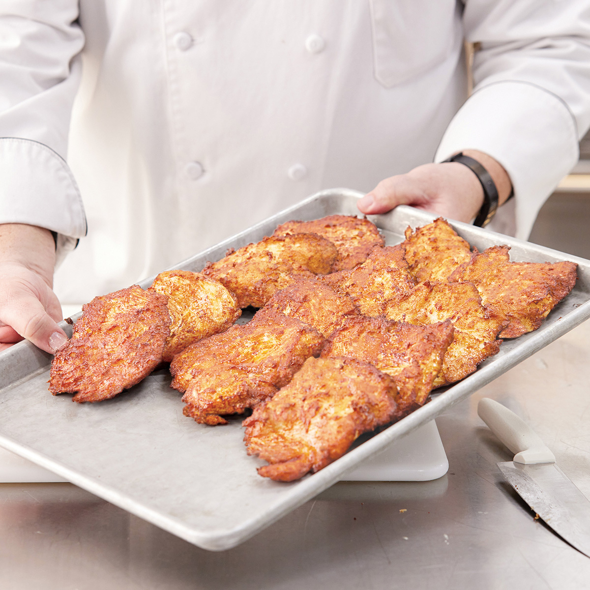 Flash 180 battered sous-vide cooked chicken breast on a cookie sheet