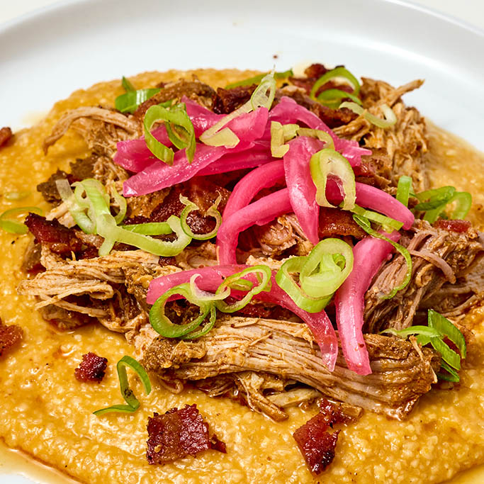 Close up of barbacoa with jalapeno bacon and grits